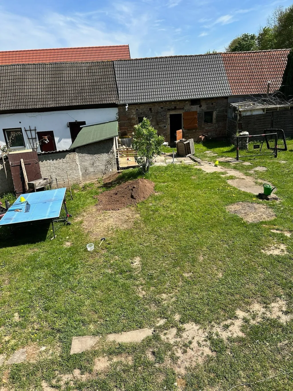 Blick auf den Hof mit Tischtennisplatte und Trampolin