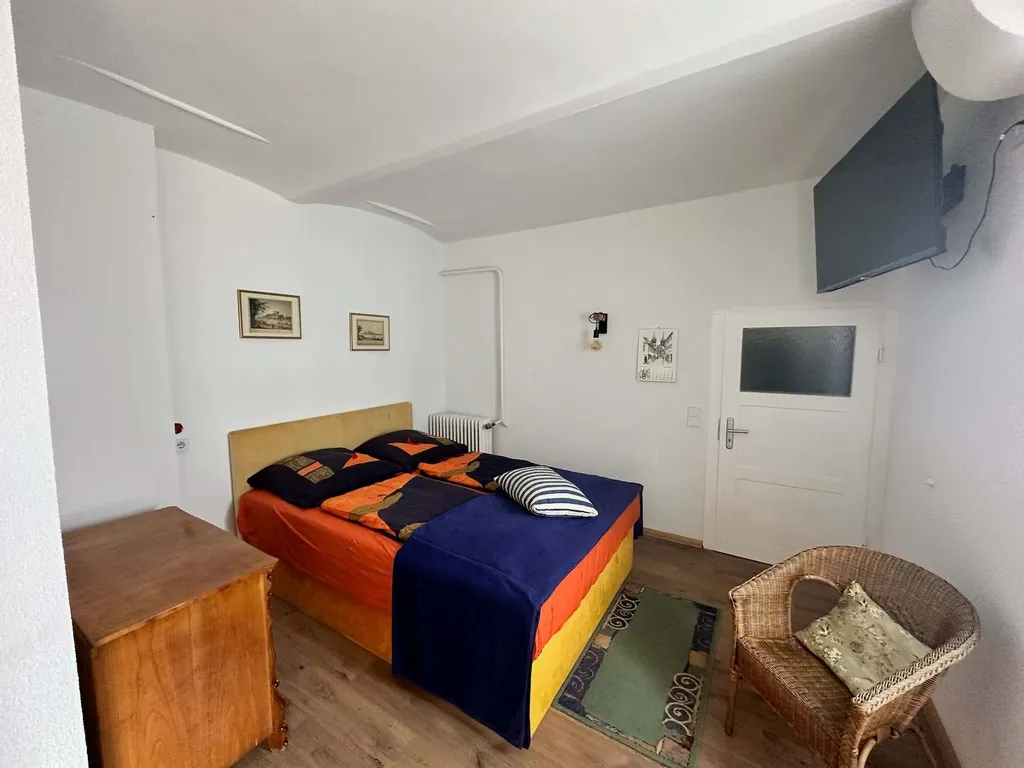 Unstruttal Schlafzimmer mit Doppelbett und Korbsessel